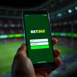 Mobile phone displaying Bet365 login screen with phone number entry field